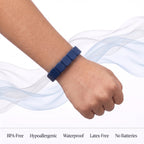 Boy's wrist with a dark blue Pulsi bracelet: BPA-free, hypoallergenic, waterproof, latex-free, no batteries